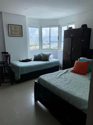 a bedroom with two beds and a large window at Apartamento torres del lago 1102 in Cartagena de Indias