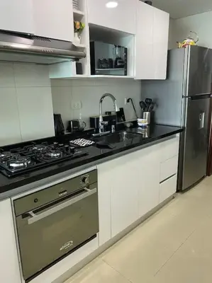 a kitchen with a stove and a sink and a refrigerator at Apartamento torres del lago 1102 in Cartagena de Indias