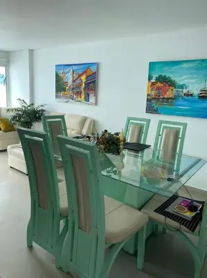 a glass dining room table with chairs and a glass table at Apartamento torres del lago 1102 in Cartagena de Indias