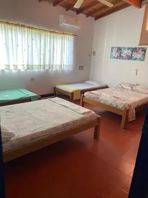 a group of three beds in a room at Cabaña Coveñas Los García in Coveñas