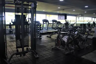 a gym with several rows of treadms and machines at Beachfront Bliss-2BR Haven Steps from Sandy Shores in Cartagena de Indias