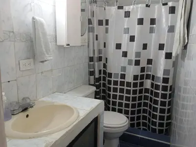 a bathroom with a sink and a toilet and a shower at @casa__grace Apartaestudio en edificio al frente del mar!! in Cartagena de Indias