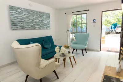 a living room with a couch and two chairs at Apartamento en Cartagena cerca al aeropuerto y Playa in Cartagena de Indias