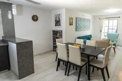 a dining room and living room with a table and chairs at Apartamento en Cartagena cerca al aeropuerto y Playa in Cartagena de Indias