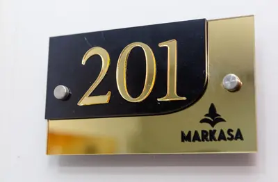 a black and gold plaque with the number at Markasa Hotel boutique in Cartagena de Indias