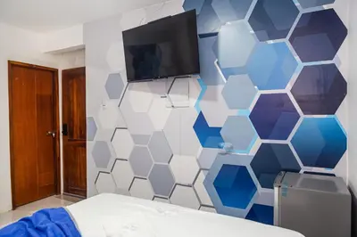a bedroom with a blue and white hexagonal wall at Markasa Hotel boutique in Cartagena de Indias