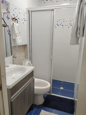 a bathroom with a toilet and a sink and a shower at casa castillo san felipe in Cartagena de Indias