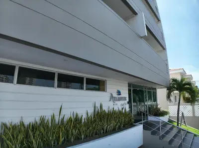 a white building with plants in front of it at Atlantis Suites BAQ -Apartamento Moderno-2-BD in Barranquilla