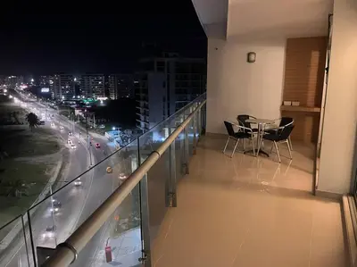 a balcony with a view of a city at night at Apartamento con vista al mar in Cartagena de Indias