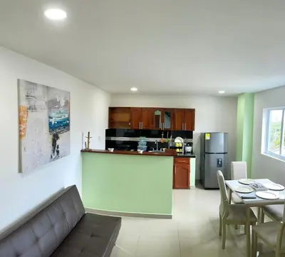 a living room and kitchen with a couch and a table at Apartamento 405 in Cartagena de Indias
