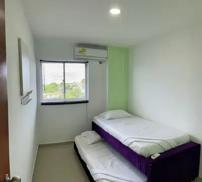 two beds in a small room with a window at Apartamento 405 in Cartagena de Indias