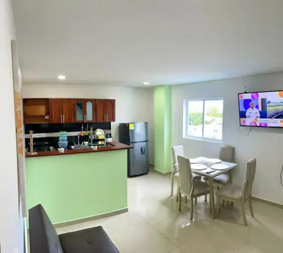 a kitchen and dining room with a table and chairs at Apartamento 405 in Cartagena de Indias