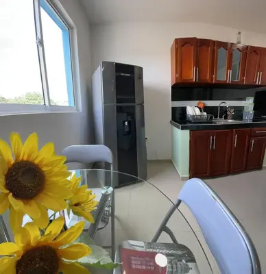 a kitchen with a glass table with a sunflower on it at Apartamento 403 in Cartagena de Indias