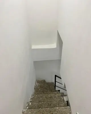 a staircase in a white room with white walls and a white ceiling at Apartamento 403 in Cartagena de Indias