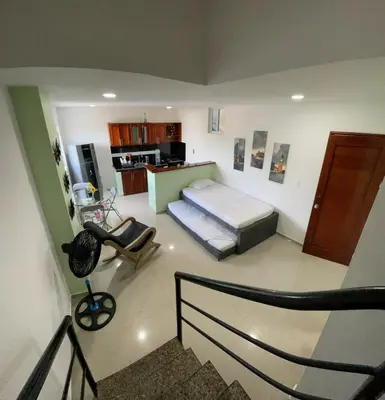 a small bedroom with a bed and a kitchen at Apartamento 403 in Cartagena de Indias