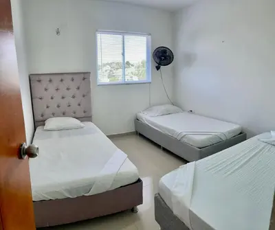 a bedroom with two beds and a window at Apartamento 403 in Cartagena de Indias