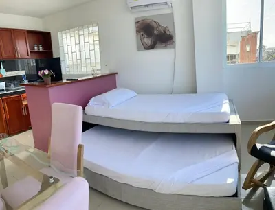 two bunk beds in a room with a kitchen at Apartamento 201 in Cartagena de Indias