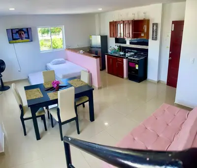 a kitchen and living room with a table and a couch at Apartamento 408 in Cartagena de Indias