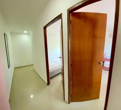 a door leading to a room with a bedroom at Apartamento 408 in Cartagena de Indias