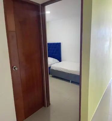 a door leading to a bedroom with a bed at Apartamento 301 in Cartagena de Indias