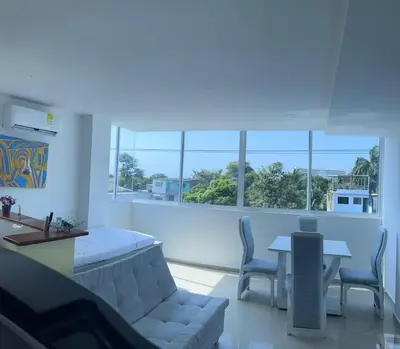a living room with a couch and a table and windows at Apartamento 301 in Cartagena de Indias