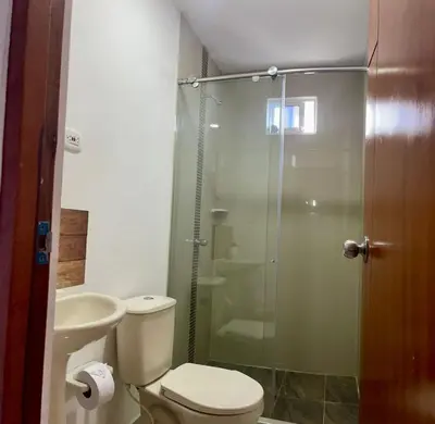 a bathroom with a toilet and a glass shower at Apartamento 204 in Cartagena de Indias