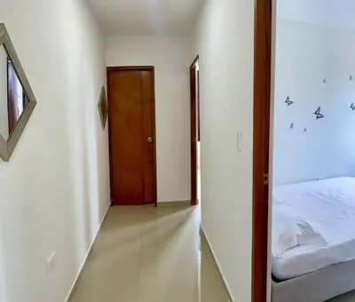 a bedroom with a bed and a wooden door at Apartamento 401 in Cartagena de Indias