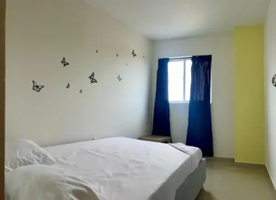 a bedroom with a bed with butterflies on the wall at Apartamento 401 in Cartagena de Indias