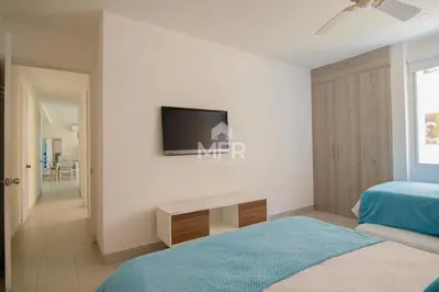 a bedroom with a bed and a tv on a wall at MORROS 922 APTO 3 ALCOBAS in Cartagena de Indias
