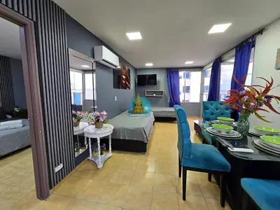 a living room with a table and a dining room at Apto Vista Lateral Mar Piso 15 in Cartagena de Indias