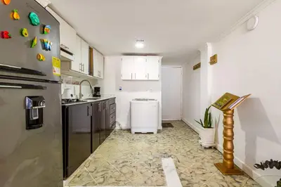 a kitchen with a refrigerator and a sink at Apartamento cerca al Mar in Cartagena de Indias