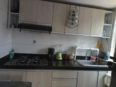 a kitchen with a stove and a sink and a microwave at Alojamiento San Felipe in Cartagena de Indias