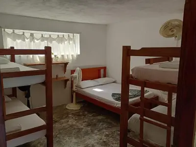 a room with two bunk beds and a window at Sol y Mar in Isla Fuerte