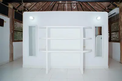 a white wall with shelves in a room at Isla Mulata, Islas del Rosario in Isla Grande