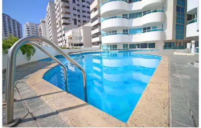 a swimming pool in front of a building at Apartamento torres del lago in Cartagena de Indias