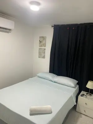 a bed in a room with a black curtain at Habitación cerca al aeropuerto 3 in Cartagena de Indias