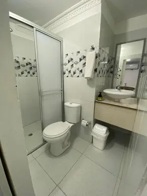 a white bathroom with a toilet and a sink at Habitación cerca al aeropuerto 3 in Cartagena de Indias