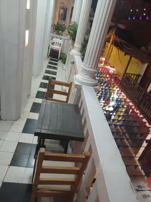 a table and chairs on the floor of a building at HOSTEL M&H in Cartagena de Indias