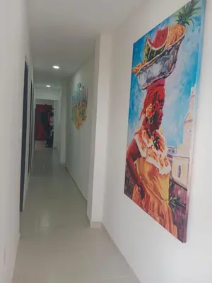 a painting hanging on a wall in a hallway at Apartamento turistico Mariangel in Cartagena de Indias