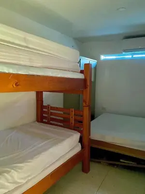 a room with three bunk beds in a room at cabaña villa Oti 1 in Ciénaga