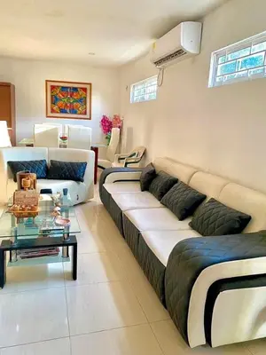 a living room with a couch and a table at cabaña villa Oti 1 in Ciénaga