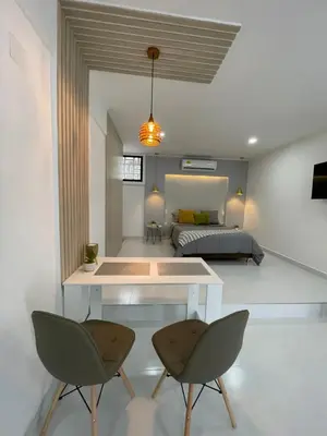 a room with a table and two chairs and a bed at Apartasuites Mardini in Cartagena de Indias