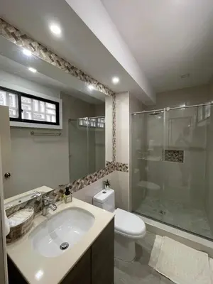 a bathroom with a sink and a shower and a toilet at Apartasuites Mardini in Cartagena de Indias