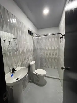 a bathroom with a toilet and a sink and a shower at HOTEL HOUSE San Antero Córdoba in San Antero