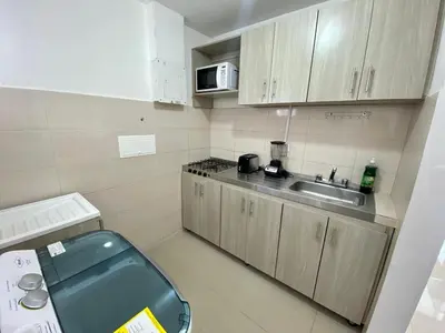 a small kitchen with a sink and a microwave at Apartamento en Cartagena, Entero y Amueblado in Cartagena de Indias