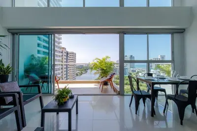 a living room with a table and chairs and a large window at APARTAMENTO EDIFICIO MONTU in Cartagena de Indias