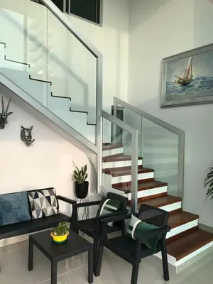 a living room with a staircase and a table and chairs at APARTAMENTO EDIFICIO MONTU in Cartagena de Indias