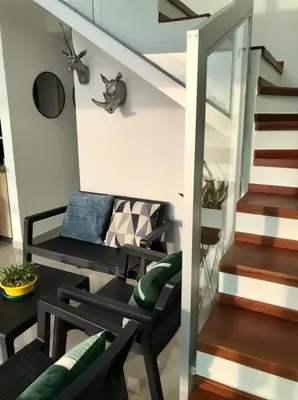 a living room with a bench and a staircase at APARTAMENTO EDIFICIO MONTU in Cartagena de Indias