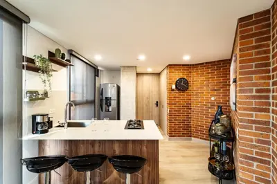 a kitchen with a sink and a brick wall at Apartamento ubicado en, LAURELES, MEDELLIN in Cartagena de Indias