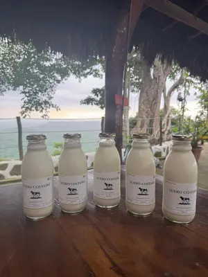 a group of four milk bottles sitting on a table at Ecohotel La Reserva in Piojó